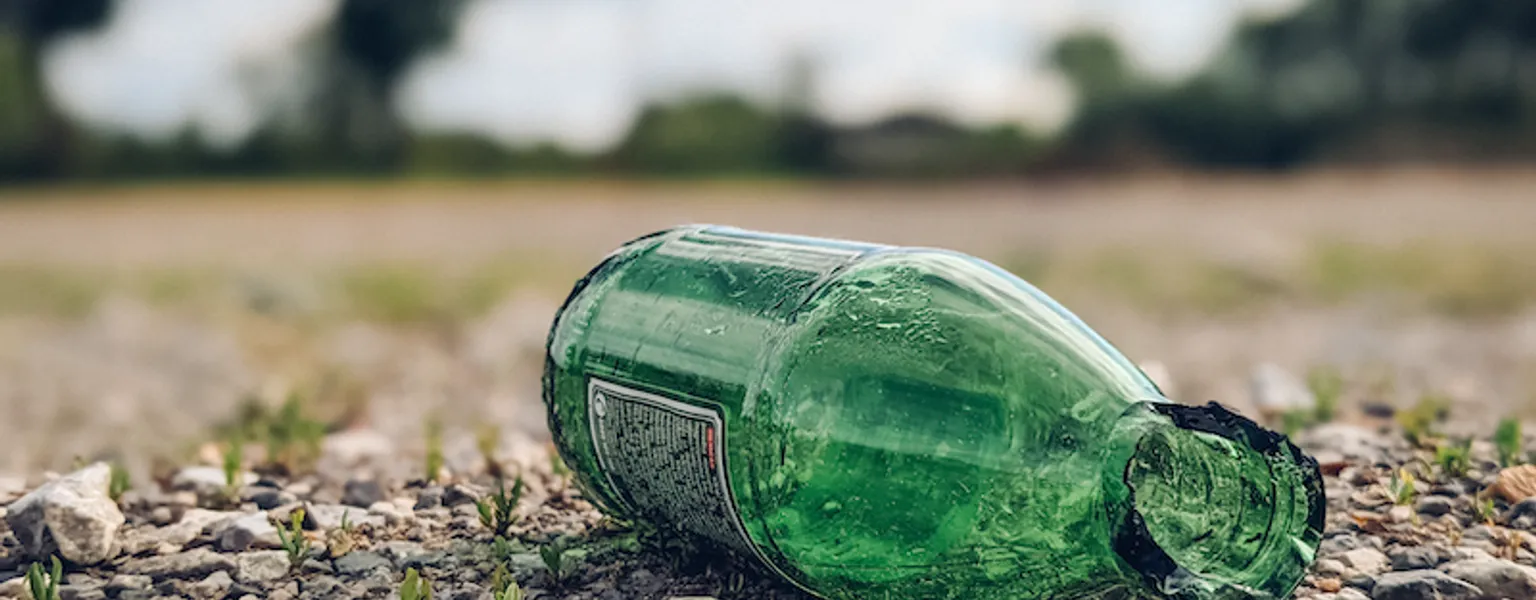 Close-up of a broken glass bottle on the ground. Glass being dumped instead of recycled credit Ivan Radic