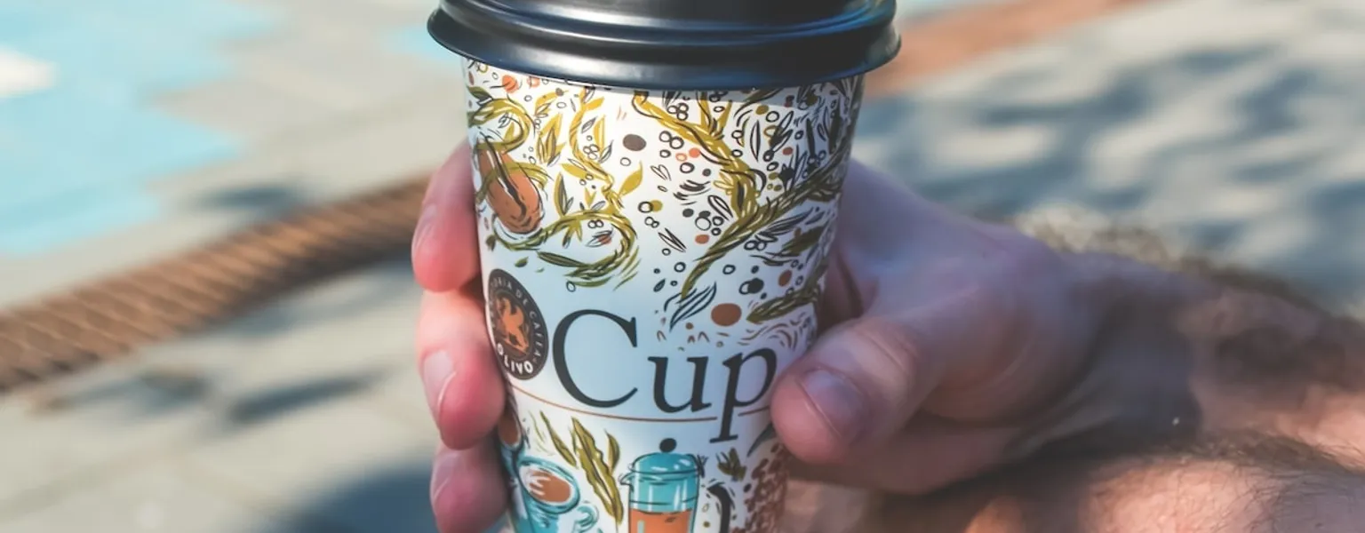 Hand holding cup of coffee credit freestocks org